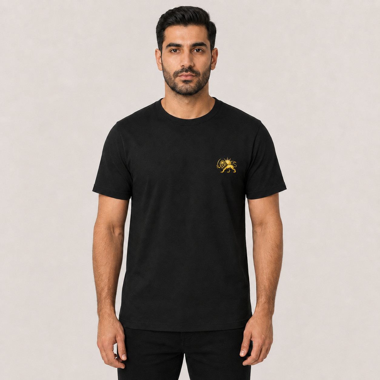 A man wearing black t-shirt with gold persian lion on the chest